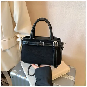 Detailed view of a black frosted retro crossbody bag with decorative buckle and dual handles