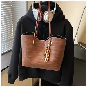 Brown woven texture large capacity tote bag featuring a stylish wooden bead charm.