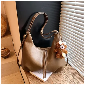 Stylish brown large capacity faux leather tote bag featuring a cute plush bear keychain