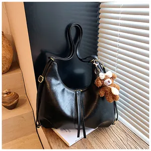 Large black multi-functional hobo bag with a cute teddy bear charm for daily commute