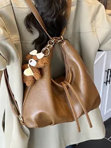 Large brown PU leather multi-purpose backpack with cute bear keychain for women.