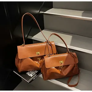 Lifestyle view of vintage brown leather underarm bags in large and medium sizes