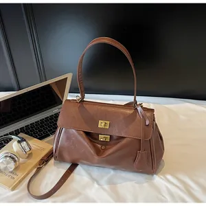 Vintage brown leather tote bag displayed with lifestyle accessories in a cozy setting