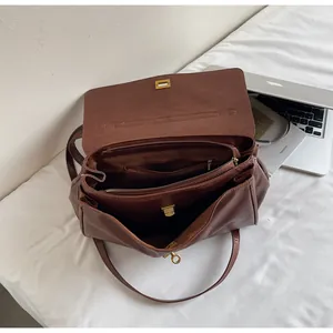 Internal compartments and zipper pockets of the vintage brown leather tote bag.