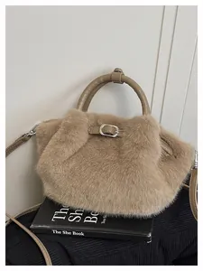 Detail view of khaki faux fur tote bag showing plush texture on a book prop