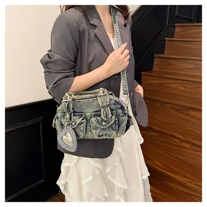 Detailed view of casual denim Boston bowling bag featuring a heart mirror charm