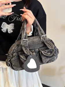 Trendy vintage washed denim Boston bag with heart mirror charm and adjustable buckle straps