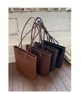 Minimalist large commuter tote bags in four vintage colors with long leather shoulder straps