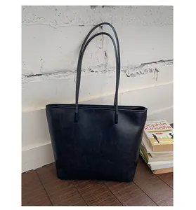 Minimalist black faux leather large capacity tote bag perfect for daily commuting and fashion