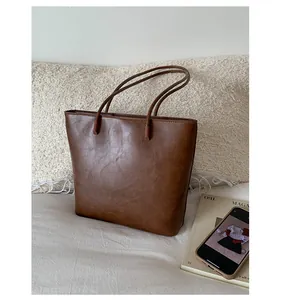 Vintage brown faux leather tote bag with large capacity for stylish daily commuting.