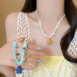 Detail view of a beaded necklace and bracelet set featuring star-shaped pendants.