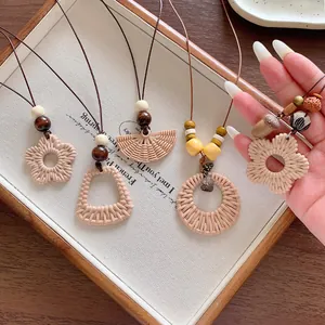 Close-up of bohemian style woven flower and geometric pendant necklaces for vacation
