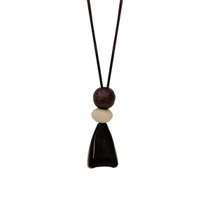 Minimalist geometric pendant necklace with wooden beads and long adjustable cord