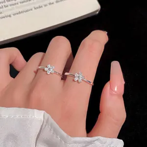 Macro view of elegant silver flower adjustable rings with delicate cubic zirconia details