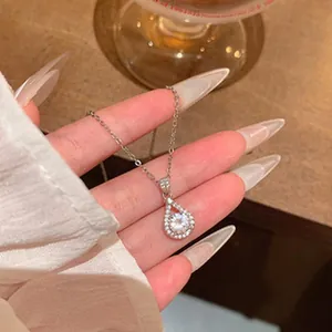 Elegant silver teardrop pendant necklace with sparkling clear central stone detail.