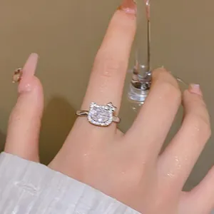 Close-up detail of the sparkling cat-shaped ring featuring a large center zircon stone.