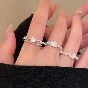 Elegant silver layered open rings with white cat's eye stones and floral design