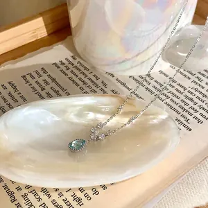 Close-up detail of silver necklace with blue waterdrop zircon pendant Mermaid Tears