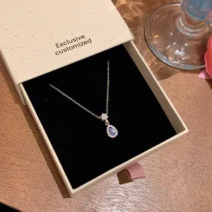 Elegant blue teardrop pendant necklace showcased in a premium gift box presentation