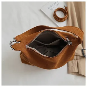 Close-up detail showing the internal zipper pocket and texture of brown suede hobo bag