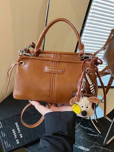Vintage bruine kunstlederen handtas met hondenbedel en afneembare schouderriem