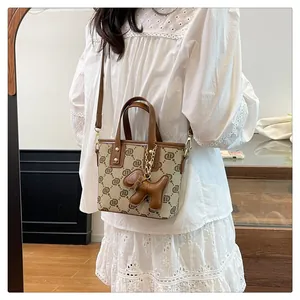 Vintage monogram bucket bag featuring a cute brown dog charm in a lifestyle setting