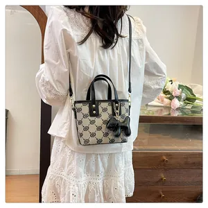 Premium monogram crossbody handbag for women with a cute balloon dog charm on a model