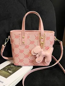 Fashionable pink monogram bucket bag for women featuring a cute dog charm and adjustable strap