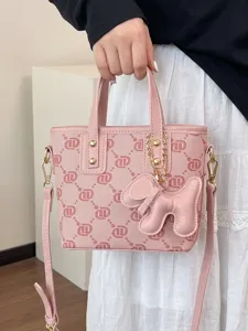 Elegant pink monogram tote bag for women featuring cute puppy charm and adjustable strap