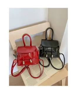 Detailed view of stylish red and black mini leather backpacks with drawstring closure