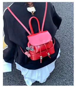 Street style lifestyle shot of a fashionable red mini backpack for women on back