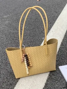 Elegant yellow woven tote bag for women featuring large capacity and a stylish beaded tassel