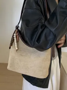Vintage large capacity beige suede bucket shoulder bag with decorative beaded charm for women