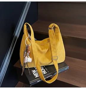 Close-up of a yellow vintage suede large tote bag placed on stairs for a lifestyle look