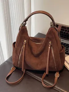 Grote vintage bruine suède draagtas met veelzijdige schouder- en rugzakbanden