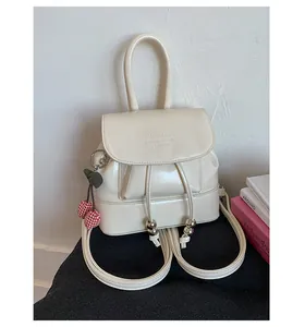 Mini off-white glossy PU leather backpack for women featuring cherry charm and flap