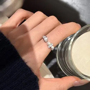 Elegant close-up of a French-style lace adjustable open ring with cat's eye stones.