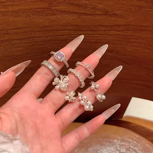 Close-up of elegant Baroque pearl rings stacked on a hand with luxury aesthetic