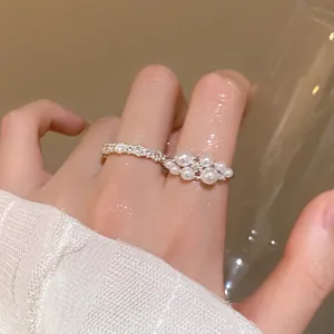 Detailed close-up of an elegant French Baroque pearl open ring worn on a finger
