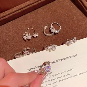 Detailed macro shot of elegant French Baroque pearl rings with sparkling crystals on velvet