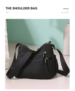Detailed view of a black multi-pocket crossbody bag for women with large capacity.