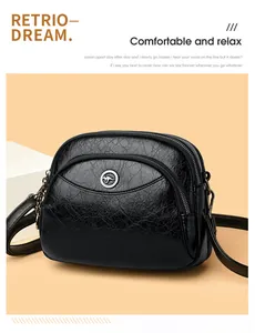 Detail view of the black textured three-layer independent zippered women's shoulder bag