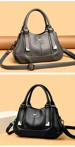 Detailed close-up showing fashionable soft leather handbags in black and grey textures