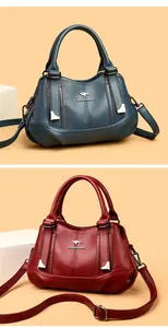 Detailed view of fashionable textured soft leather handbags in blue and red colors