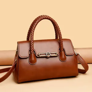 High-quality brown leather handbag with braided handles and adjustable crossbody strap