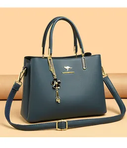 Elegant dark teal leather handbag for women featuring gold kangaroo logo and flower charm