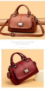 Detail view of an elegant leather handbag with woven edges and kangaroo logo plate