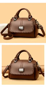 Brown pebbled leather handbag with woven flap and metal brand logo detail