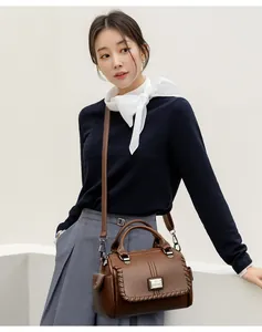 Elegant brown leather handbag worn by a model for a stylish lifestyle photoshoot session.