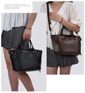 Detailed view of women's vintage large capacity leather handbag in black and brown colors